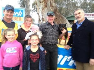 Clark Rubber owner Chris Malcolm, far right with Rob Buckley, holding Burgess, with wife Toni and daughter Molly. At left is breeder Andrew Kennedy, daughters Clare and Maggie. 