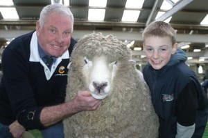 Stanbury Corriedale stud principal Geoff Risbey with his supreme longwool exhibit at Ballarat, Jim, and Austin Parker.