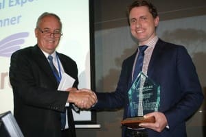 Former ALEC chairman Peter Kane presents the 2014 Landmark Livestock Export Young Achiever award to Austrex's Tom Slaughter.