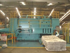 A dump press at one of AWH's storage centres with tri-packed bales in forground. Picture: AWH Pty Ltd.