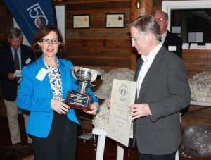 Australian Country Spinners chief executive officer Brenda McGahan, left, presents the ASWGA Cleckheaton trophy to Avington Farm co-principal Noel Henderson, with fleece competition co-ordinator, Danny Picker and  ASWGA president John Taylor in the background. Photo: Courtesy Ian Cathles.