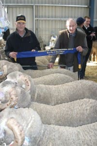 Willandra Merino Stud sales manager Peter Jeffs, left, with stud principal Ross Wells, and their top pen of five rams.