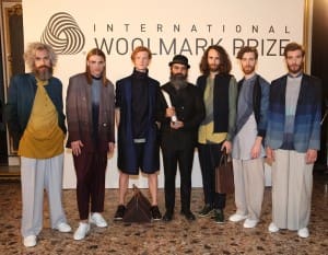 Woolmark Prize menswear award- winning designer Suket Dhir, flanked by models wearing his designs.