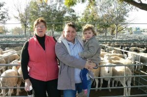 Meringur lamb producer Annette Lambert, centre, with Lacey, and Karen Rudd, sold 16 crossbred lambs for $138 at Ouyen.