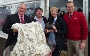 With a fleece from the Elders Supreme Southern Clip of the Year were, from left, Elders southern zone general manager Malcolm Hunt, winners Allan and Jenny Johnson, and Elders southern zone wool manager Lachie Brown.