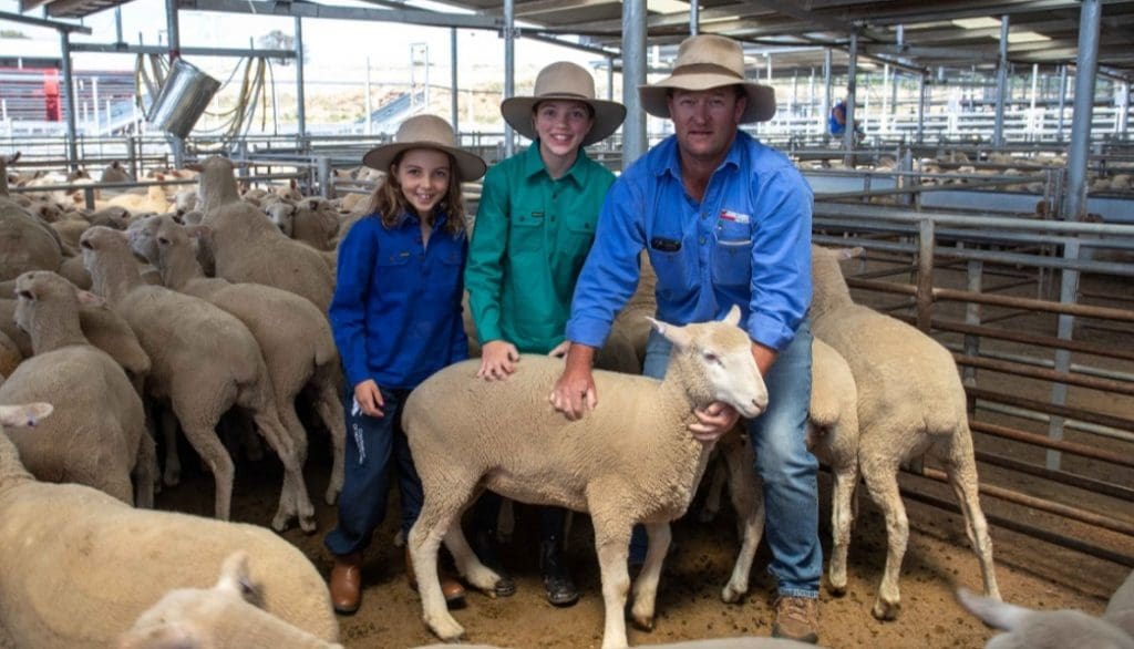 Saying goodbye to their poddy lamb Alex, were Sienna and Somer Gann